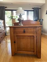 Front view of wood wash stand cabinet with drawer and door closed