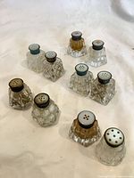 All ten glass shakers grouped, showing matched pairs and singles