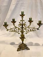 Front view showing full five-arm brass candelabra