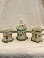 Front view of three custard glass pieces