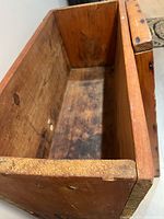 Interior view of wooden dough box showing dovetail joints and wear