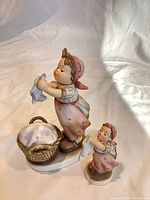 Front view of both Hummel Wash Day figurines