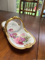 Top view showing floral painting and gold handle
