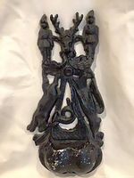 Front view of cast iron match holder showing complete design