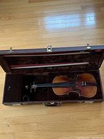 Open violin case with violin and bow