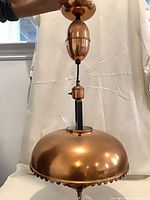 Copper dome pendant light showing shade and counterweight