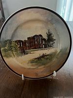 Front view showing Kenilworth Castle scene and rim