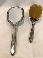 Hand mirror and hair brush front view