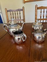 All four silver plated pieces on table