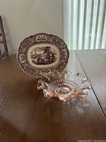 Front view of transferware plate and pink fluted glass dish