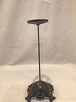 Full view of metal hat stand showing height and base