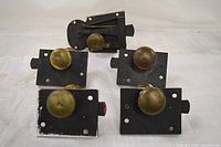 Group shot of five rim locks showing overall forms and knobs