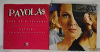 Front covers of Payola$ 12-inch single and Styx Pieces of Eight LP shown side by side