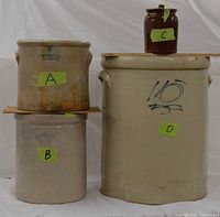 All four crocks grouped, showing relative sizes and colors