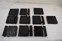 Ten black-primed rim lock bodies with separate keepers laid out on table