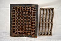 Cast iron and wood floor grates side by side