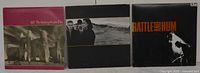 Front view of three U2 album jackets