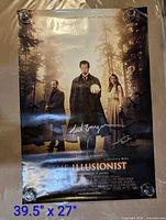 Full view of signed Illusionist poster with dimensions text overlay
