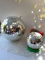 14" electric disco ball next to 6" ball; boxed 8" balls partially visible
