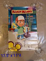 Full view of first signed Handy Manny poster with suction cups at corners