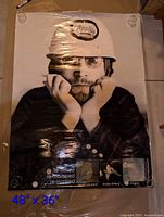 Full view of poster showing John Lennon in Apple helmet