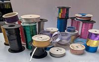 Group of ribbon spools assorted colors and sizes