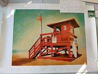 Full view of the signed print with lifeguard tower and margin showing artist name