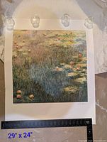 Full view of water lilies print on paper with binder clips and ruler showing scale