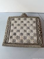 Top view of carved stone chessboard showing pattern and border