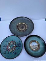 All three plates shown together for scale and contents