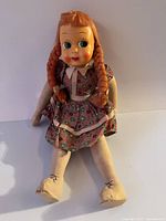 Full view of the handmade cloth rag doll seated