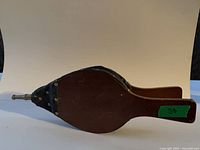 Full side view of wood and leather bellows showing nozzle and handle