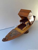 Overall view of wooden gondola cigarette holder with lid open showing two ribbed trays