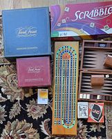 Overview of all games: cribbage board, Trivial Pursuit, Scrabble, travel backgammon, UNO, Cats of the World cards