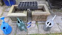 Overview of cedar planters, watering cans, clogs, seed trays