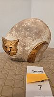Front of stoneware cat showing gold accents and mouse imprint