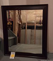 Front view of rectangular mirror with wood-tone frame