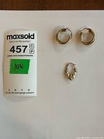 Overview of three gold hoop earrings on white background