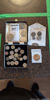 Overview of lot showing presentation case with coins, Roman coin set, Yosemite coin