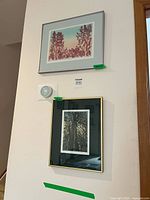 Both framed etching prints hung on wall