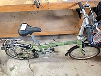 Full view of folded green Dahon bicycle