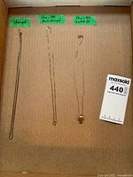 Overview of three necklaces in tray