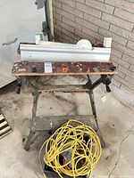 Workmate with Miter Mate attached, cords in bin