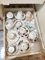 Drawer view showing 11 cup and saucer pairs