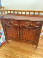 Front view showing drawer, doors, hardware, full cabinet