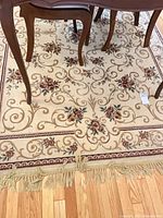 Full view of rug under dining table showing overall design, colors and fringe