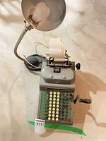 Top view of R.C. Allen 615 adding machine with desk lamp attached, paper roll installed