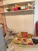 Overview of bins, cords, shelves with paint cans