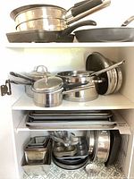 Full cabinet view showing stacked cookware and bakeware