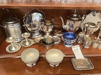 Overall shot showing majority of silver-plated items on shelf